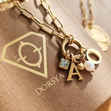 Gold necklace with charms on a DORSYA branded card