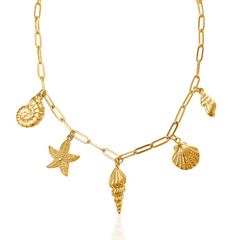 Gold necklace with shell and starfish charms on a white background