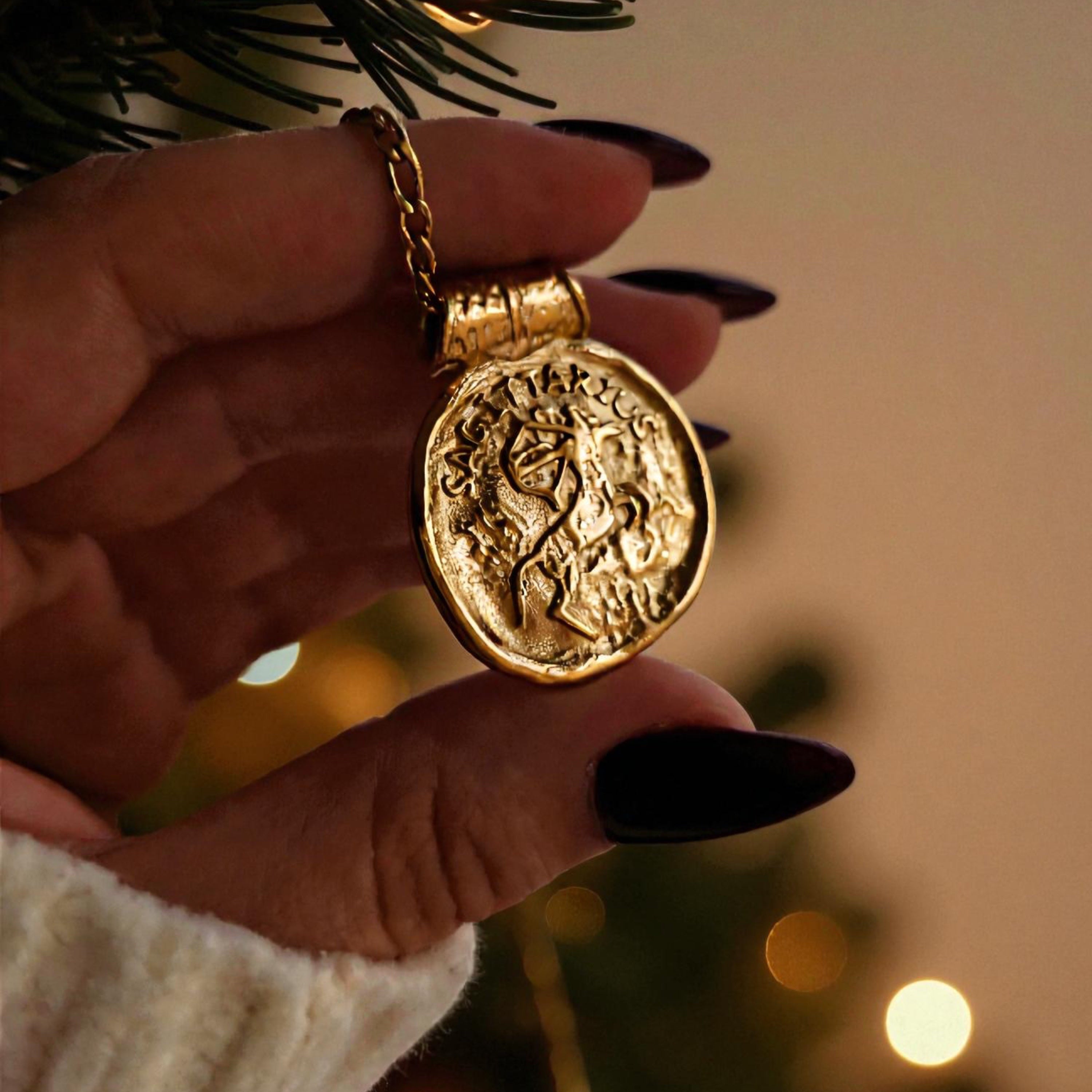 Gold necklace with a zodiac horoscope pendant.